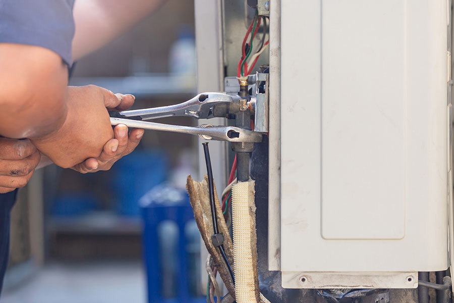 Technician repairing AC unit