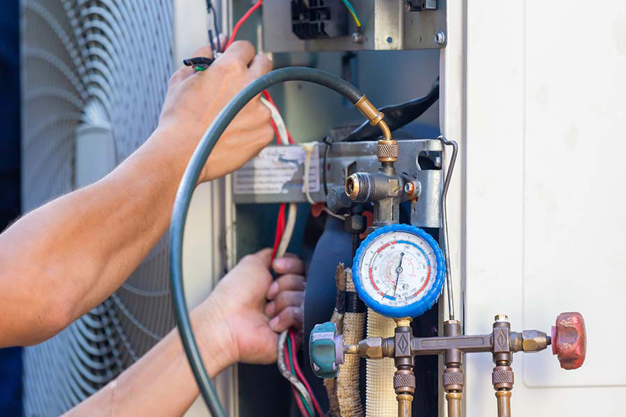 AC technician checking refrigerant