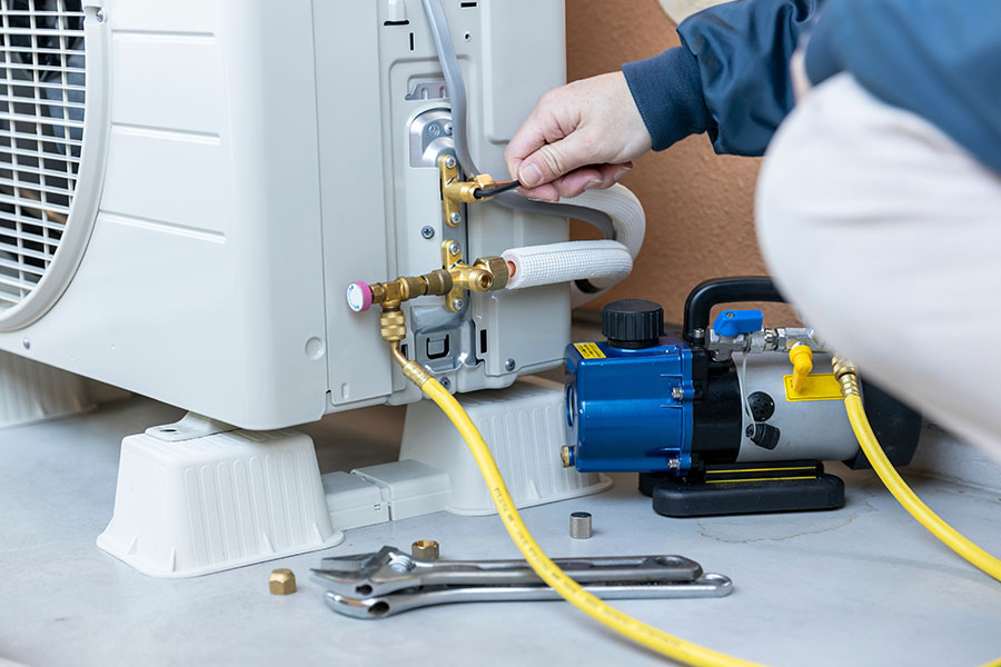 Technician servicing AC unit